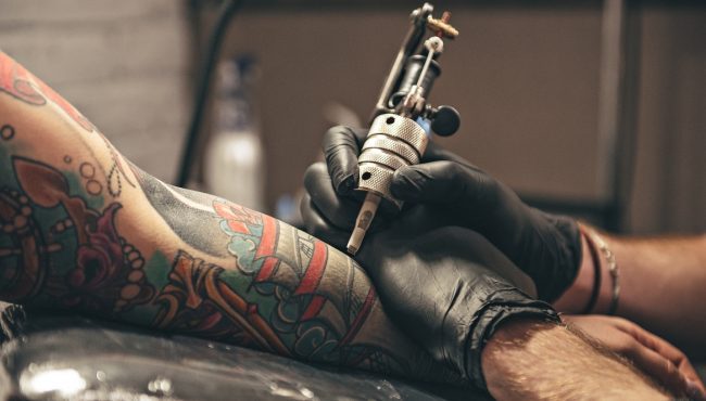 Tattoo artist working
