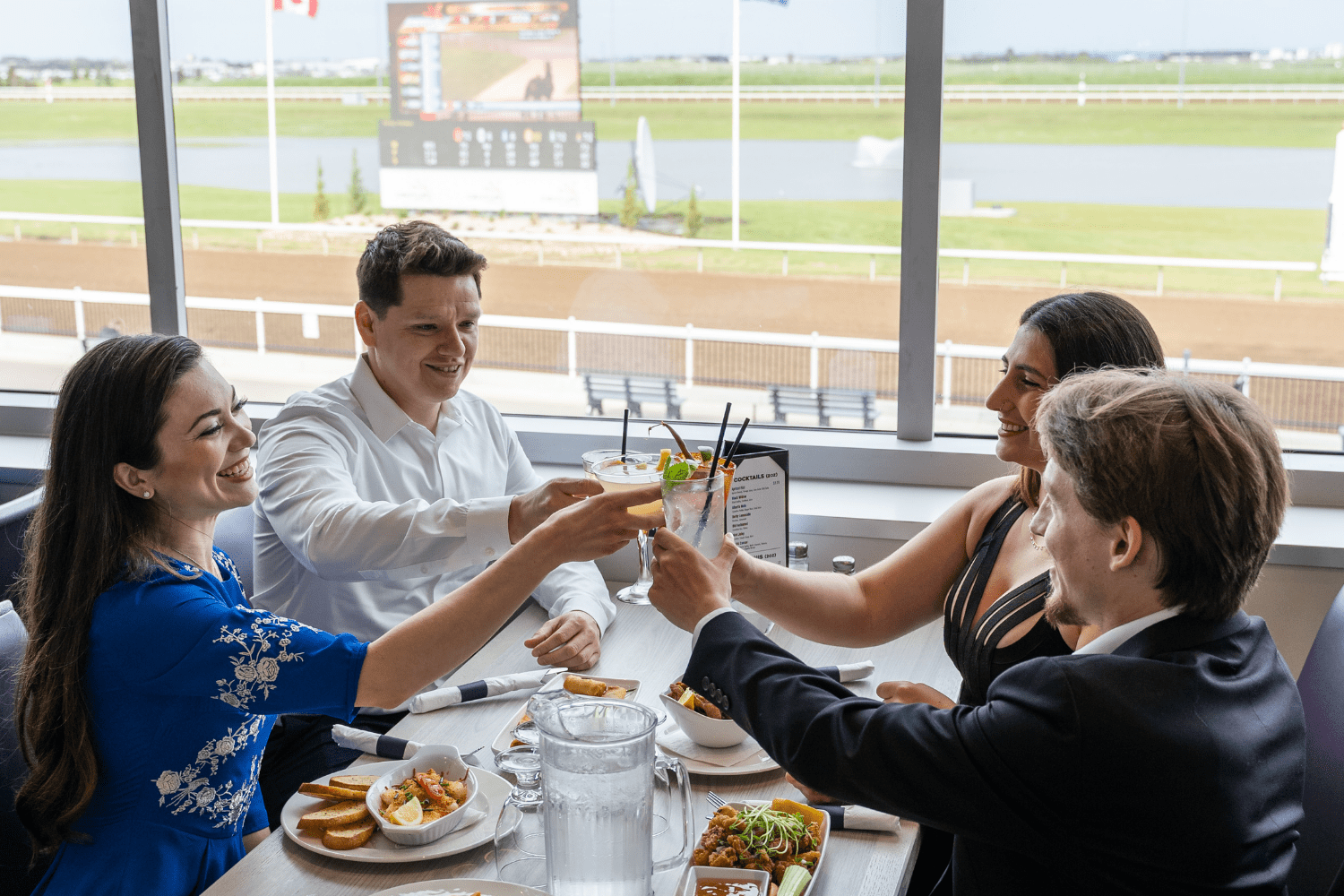 Century Mile Racetrack - Friends cheersing over dinner